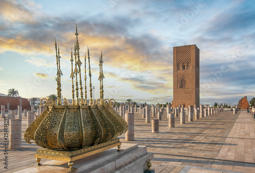 The Mausoleum of Mohammed V is a historical building located on the opposite side of the Hassan Tower on the Yacoub al-Mansour esplanade in the capital city of Rabat, Morocco at sunset. photo
