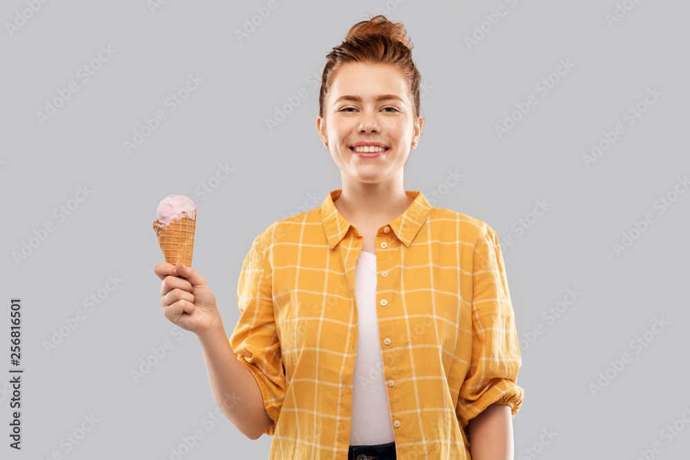 food, dessert and people concept - smiling red haired teenage girl in checkered shirt holding ice cream cone over grey background food, dessert and people concept - smiling red haired teenage girl in checkered shirt holding ice cream cone over grey background