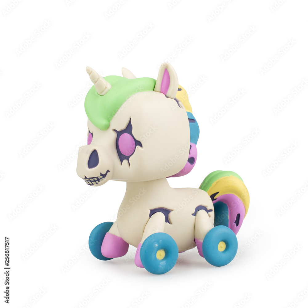 Baby toy unicorn on wheels on white background