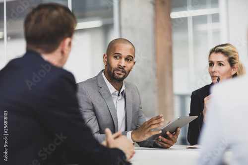 African American businessman leading a corporate meeting