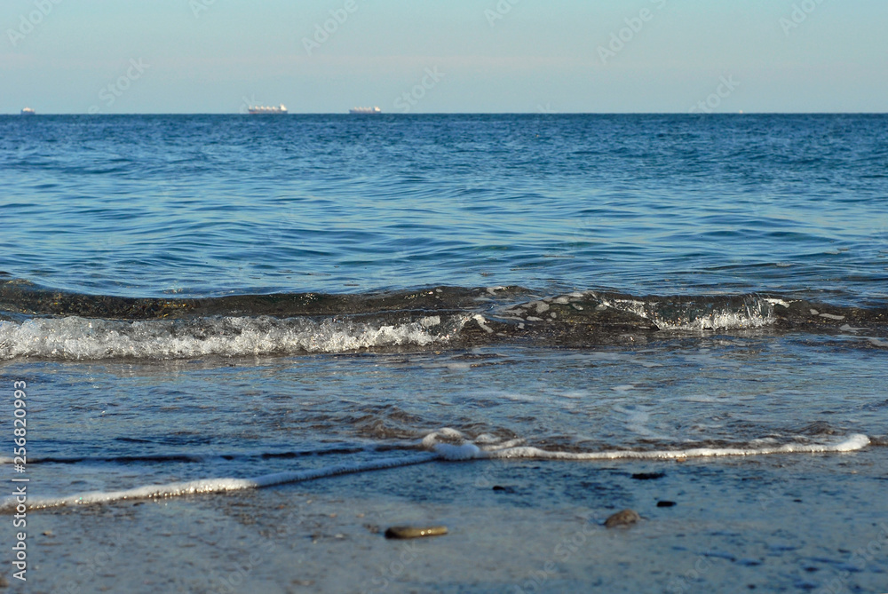 Rocky coast of the sea. Waves on the beach. Blue sea water. Rocky coast of the sea. Waves on the beach. Blue sea water.