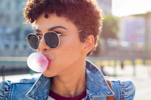 Woman blowing bubble gum balloon