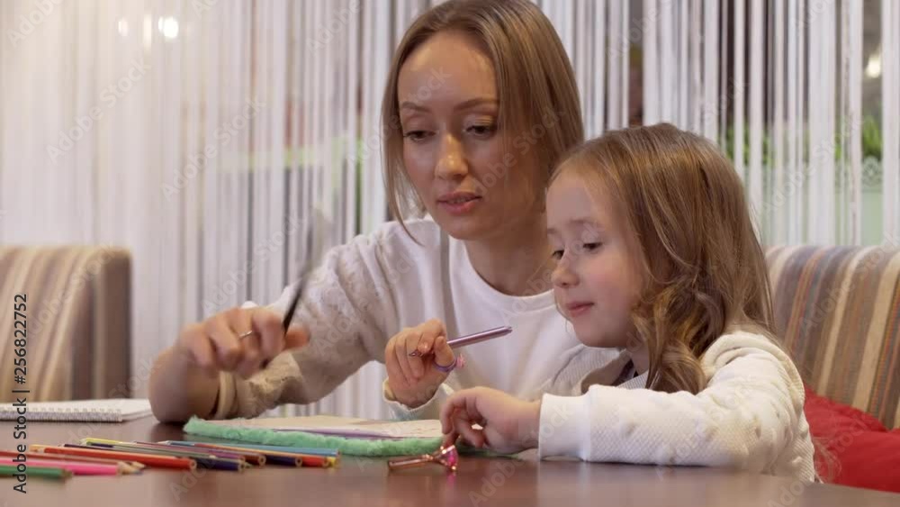 Charming Young Woman Mother Draws With Her Cute Little Daughter Charming Young Woman Mother Draws With Her Cute Little Daughter