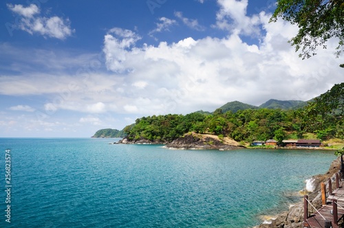 Wooden pathway and tourist resort at the volcanic coastline of the tropical Koh Chang Island, Thailand.