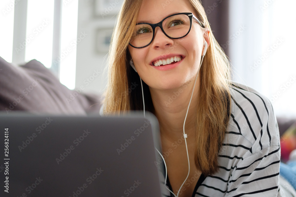 Girl spends time at home in front of a computer