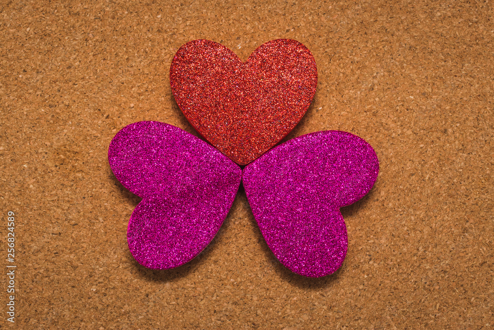 Fototapeta premium top view of three heart shapes over a brown background