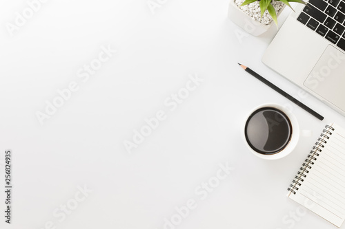 Flay lay, Top view office table desk with keyboard, coffee, pencil, leaves with copy space white background.