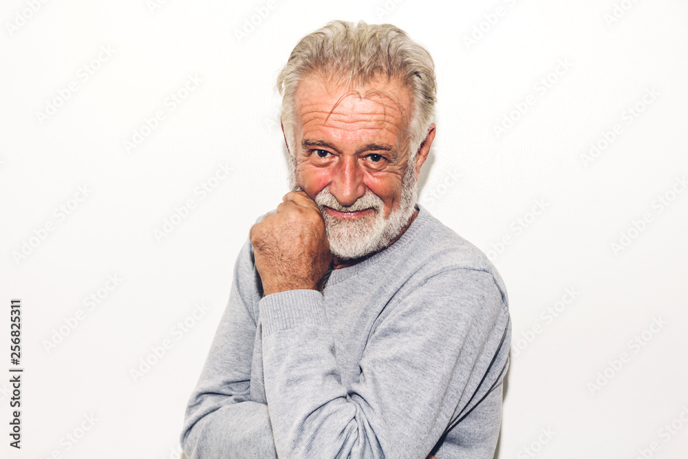 Portrait of happy smiling senior man looking at camera while standing on white background Portrait of happy smiling senior man looking at camera while standing on white background