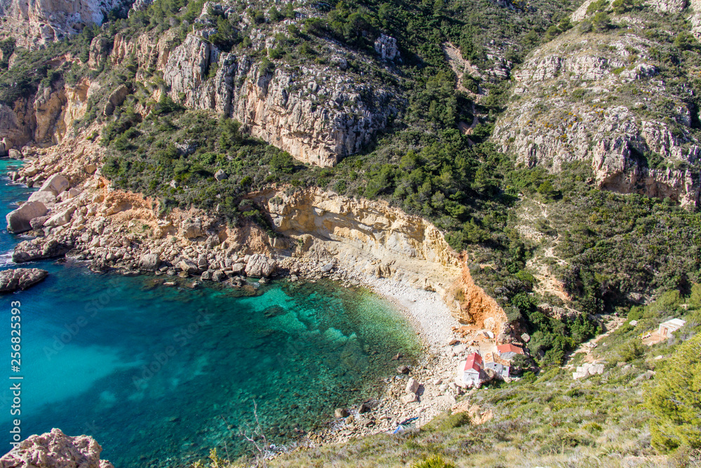 Llevant hidden cove beach in Benitatxell, Spain, with some fishermen houses