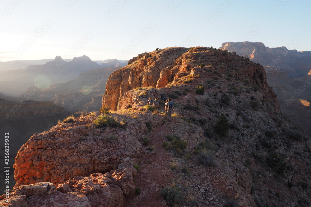 Hikers enjoy the sunset on the northewestern tip of Horseshoe Mesa in Grand Canyon National Park, Arizona.