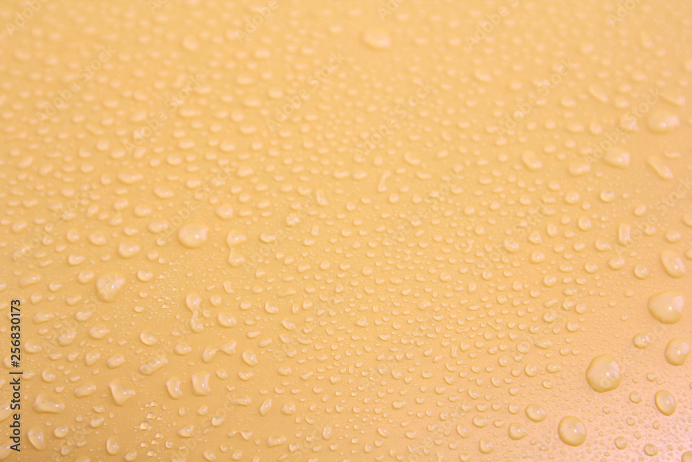 Water drops on a yellow background. Water drops on a yellow background.