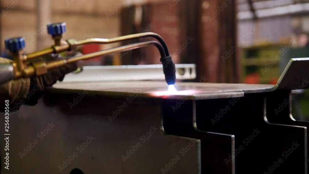 Construction plant. A worker heating up the iron detail Construction plant. A worker heating up the iron detail
