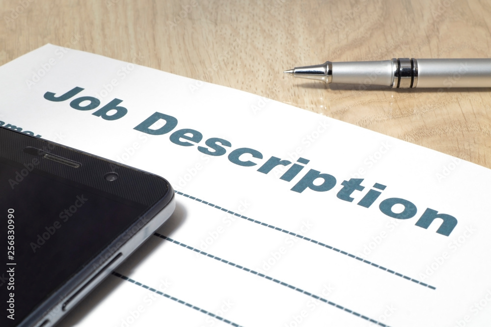 Fototapeta premium Job Description with smartphone and Pen on the table.