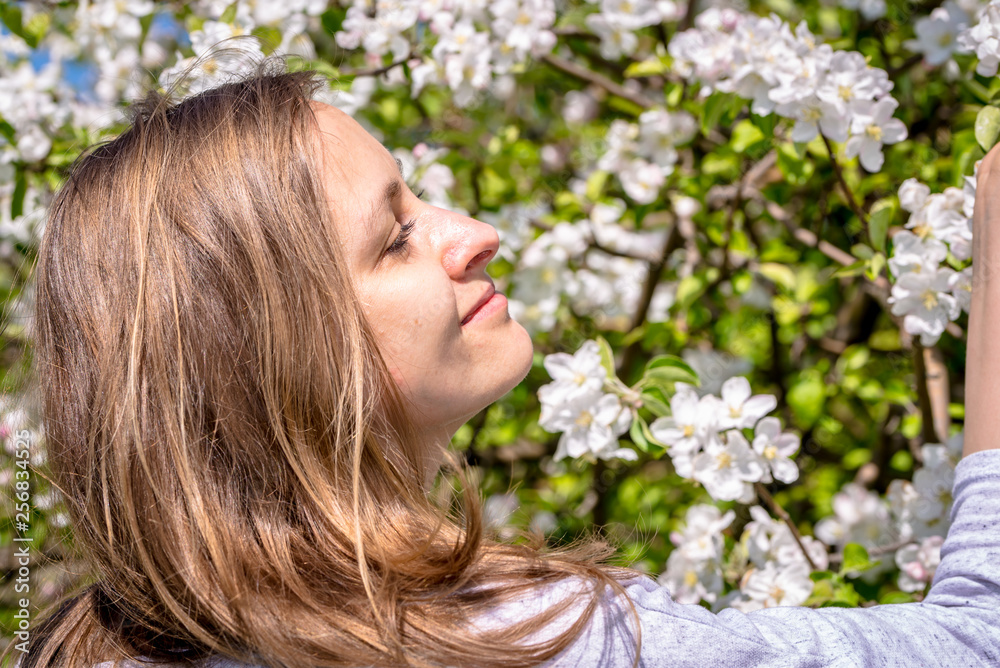 Beautiful woman among spring blossoms in the garden Beautiful woman among spring blossoms in the garden