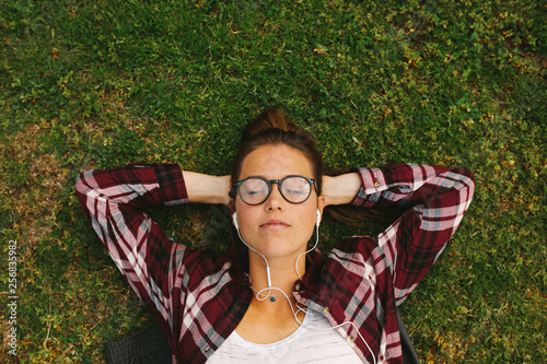 Fotografie Female student relaxing at campus
