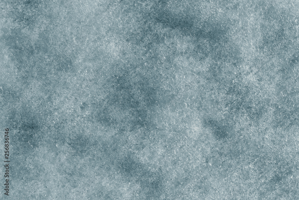Thawed snow with a beautiful ice texture, top view, blue background Thawed snow with a beautiful ice texture, top view, blue background