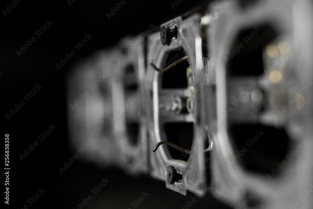 Fototapeta premium Five outlets in line, disassembled and mounted in black glass wall