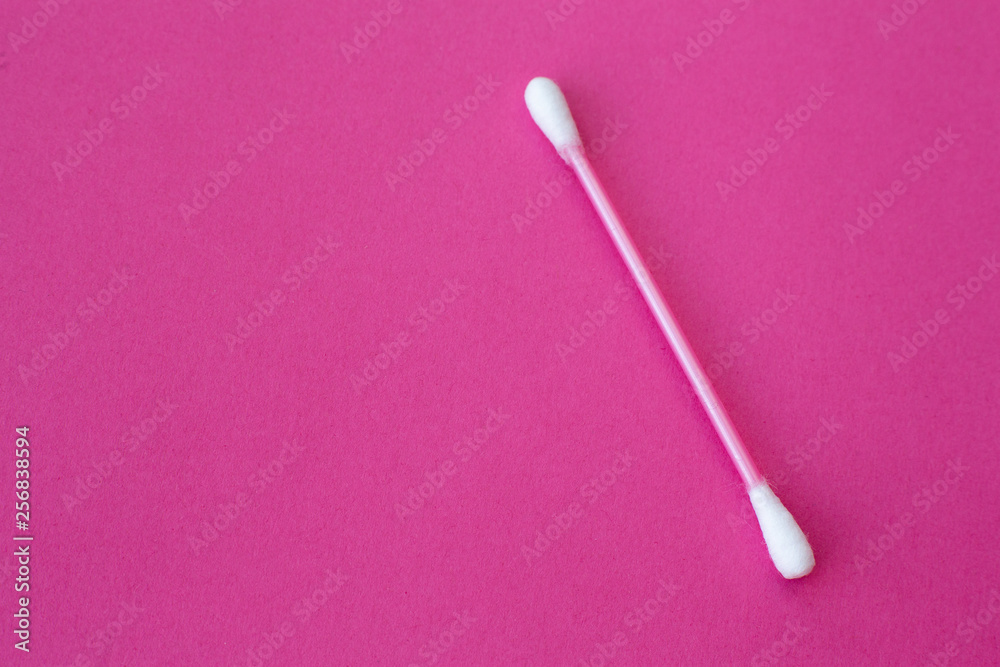 pink cotton buds with white heads laid out on a pink background pink cotton buds with white heads laid out on a pink background