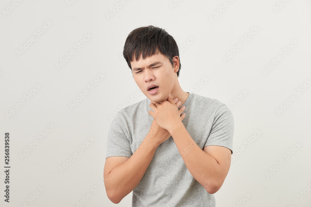 Young Asian man having sore throat / throat related diseases Young Asian man having sore throat / throat related diseases