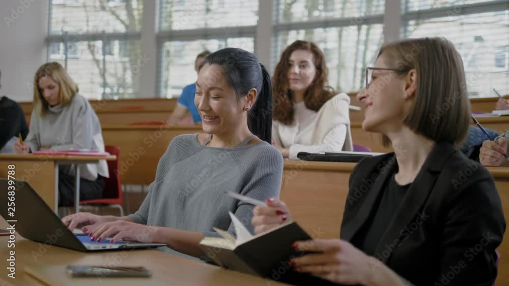 Multinational group of students in an auditorium Multinational group of students in an auditorium