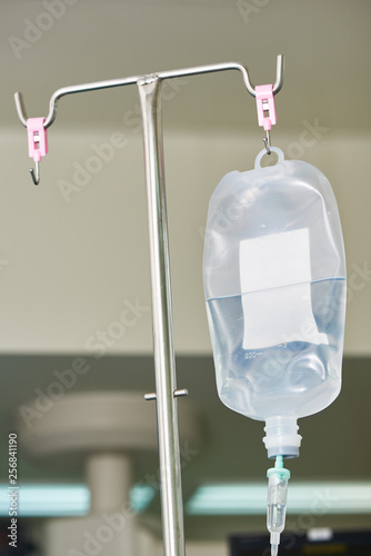 An intravenous fluid hanging on the pole