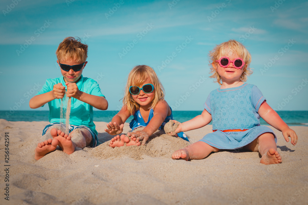 cute boy and girls playing on beach cute boy and girls playing on beach