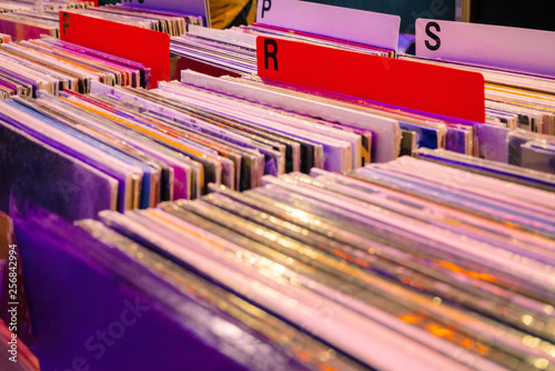 Browsing through old vinyl records in music shop. Music background.