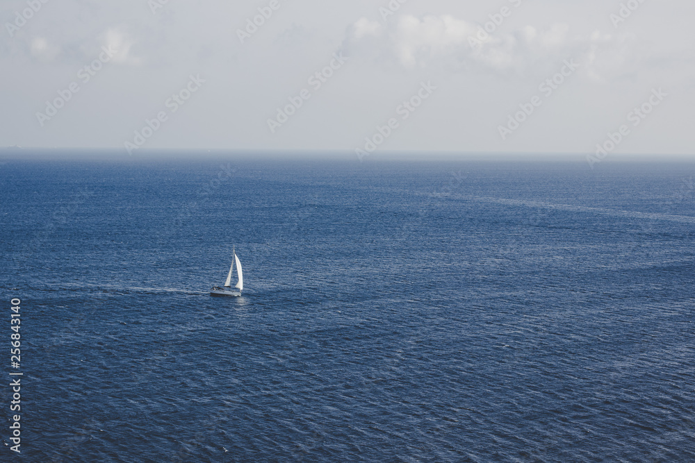 tourism cruise vacation travel concept photography of lonely yacht on calm water surface in open sea natural scenic environment, simple landscape pattern with empty copy space