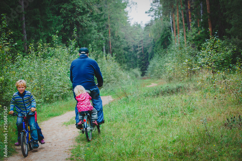 active senior with grandkids riding bikes in nature © nadezhda1906