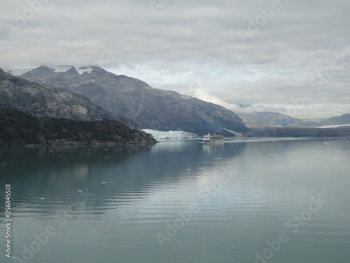 Glacier in the midst of gray mountains with little vegetation in Alaska