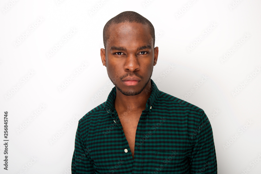 Close up cool young african american male fashion model against isolated white background Close up cool young african american male fashion model against isolated white background