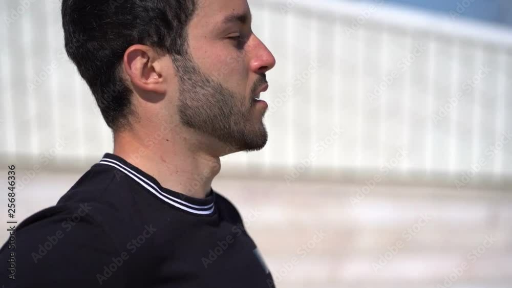 Side view of focused bearded man running outdoor. Profile view of handsome young sportsman jogging on street at sunny day, tracking shot. Working out concept Side view of focused bearded man running outdoor. Profile view of handsome young sportsman jogging on street at sunny day, tracking shot. Working out concept