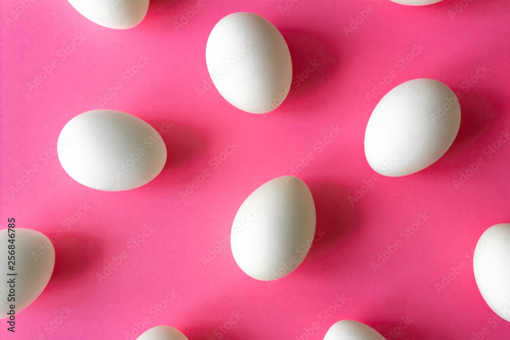 white eggs on a bright pink color background. Easter concept white eggs on a bright pink color background. Easter concept