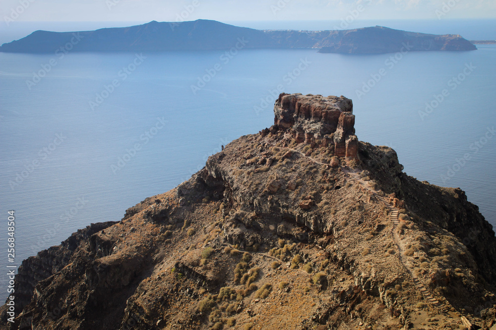 A large rock on the background of the Aegean Sea. View from the island of Santorini, Greece.