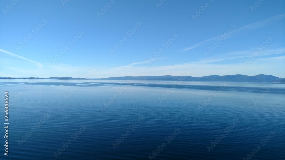 Mountain Filled horizon on the pacific ocean. Inside passage Alaska. Beautiful blue waters and sky Peaceful landscape