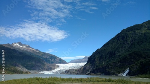 Mendenhall Glacier Juneau Alaska. Mendenhall Glacier flowing into Mendenhall Lake in between mountains with Nugget falls. Perfect tourist location