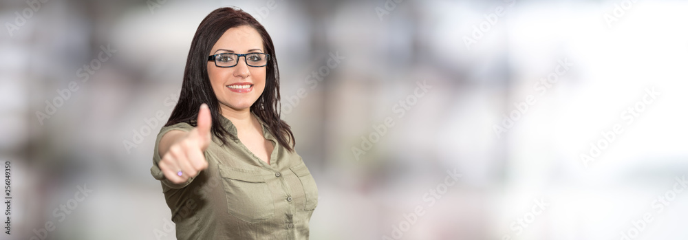 Portrait of businesswoman with thumb up