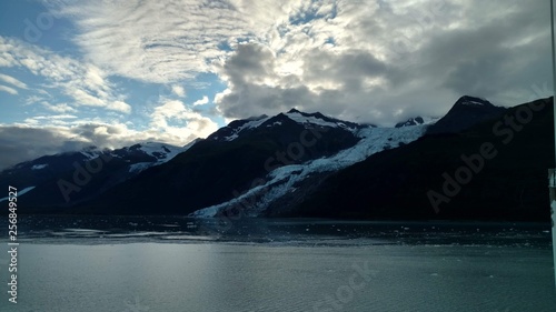 Glaciers within Glacier Bay National Park in Alaska. Glaciers coming over mountain peaks and sliding into the Pacific Ocean © Justin