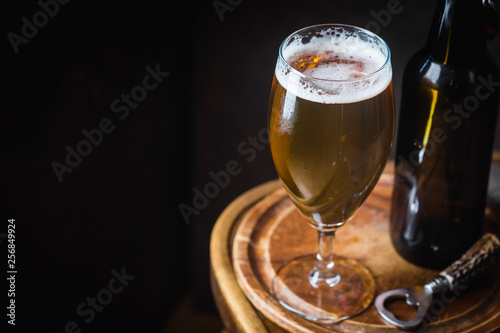 Glass beer on dark background with copy space