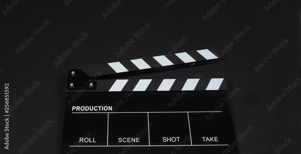 Obraz premium Black Clapperboard or clap board or movie slate use in video production ,film, cinema industry on black background.