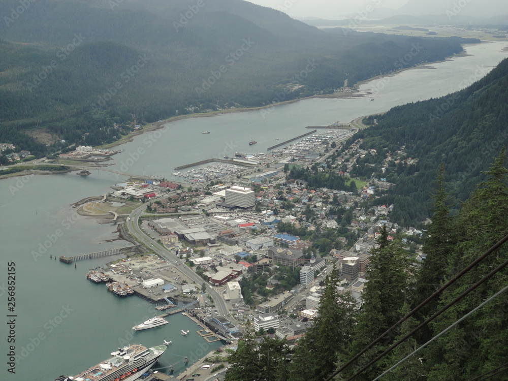View of Juneau Alaska from atop a mountain with cruise ships docked at the port and tram car
