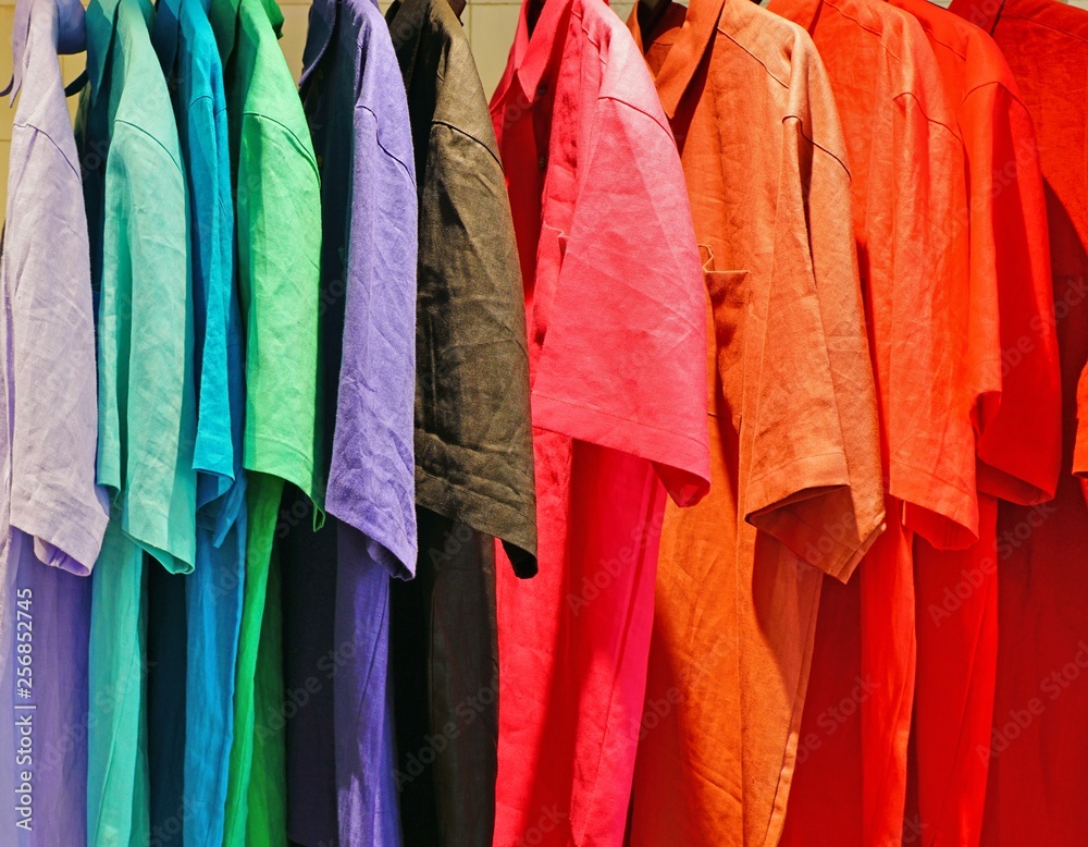 Colorful linen shirts hanging in a store