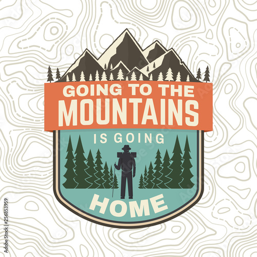 Going to the mountains is going home. Vector. Concept for shirt or badge, overlay, patch tee. Vintage typography design with hiker, mountains and forest silhouette. Outdoor adventure symbol