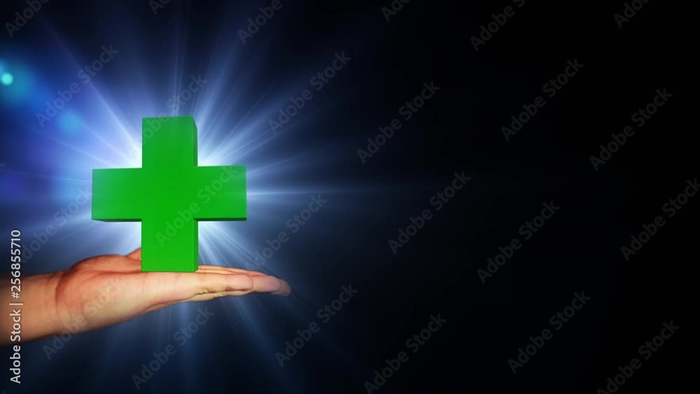 Big green cross with bright light in hand. 56.