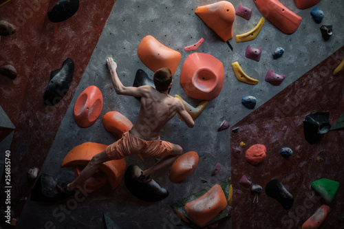 Athletic man practicing in a bouldering gym