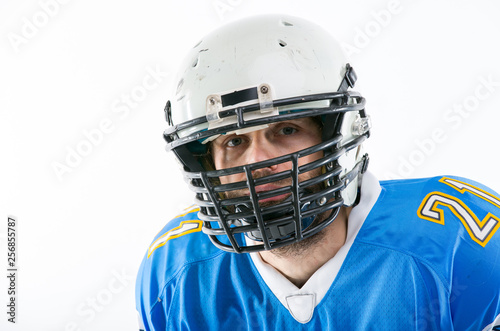 Man in blue American football player uniform, portrait. © PaulShlykov