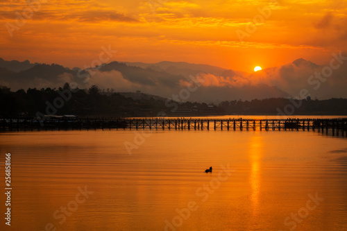 Summer sunset or sunrise over the Mon Bridge is the long wooden bridge. Attanusorn Bridge. Is the route of the villagers cross to Mon village, Sangkhla Buri, Kanchanaburi, Thailand 24 Jan 2019