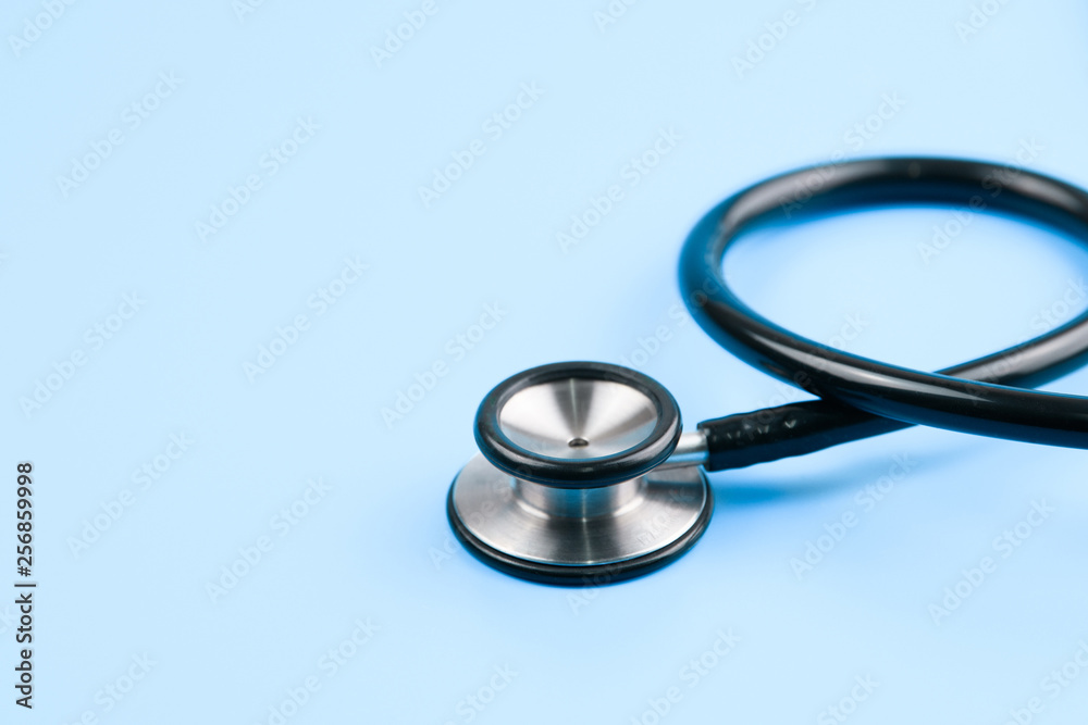 Black stethoscope and injection vaccine on blue background, medicine and drug concept Black stethoscope and injection vaccine on blue background, medicine and drug concept