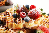 Waffle. Traditional belgian waffles with fresh fruit and powder sugar on wood