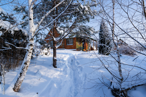 Traditional country russian house , wildly known  as  dacha, during a nice winter snowy morning